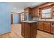 Kitchen featuring stainless steel refrigerator and oven and an island with tile backsplash at 2003 Graystone Pkwy, Grayson, GA 30017