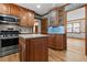 Kitchen with stainless steel oven and an island and view of the adjacent room at 2003 Graystone Pkwy, Grayson, GA 30017