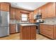 Kitchen featuring stainless steel appliances, wooden cabinetry, and a center island at 2003 Graystone Pkwy, Grayson, GA 30017
