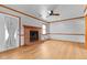 Bright living room with wood floors, brick fireplace, back door and a ceiling fan at 2003 Graystone Pkwy, Grayson, GA 30017
