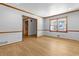Bright living room featuring beautiful hardwood floors, large windows, and neutral paint at 2003 Graystone Pkwy, Grayson, GA 30017