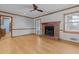 Relaxing living room showcasing a brick fireplace, hardwood floors, and a rear door at 2003 Graystone Pkwy, Grayson, GA 30017