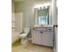 This bathroom features a bathtub, toilet and vanity with lighting, neutral walls, and tiled floors at 3855 Shelleydale Dr, Powder Springs, GA 30127
