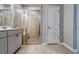 This bathroom features a walk-in shower, tiled floor, neutral walls and a double sink vanity at 3855 Shelleydale Dr, Powder Springs, GA 30127