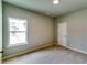 This bedroom features a window overlooking the driveway and street, soft carpet floors and neutral colored walls at 3855 Shelleydale Dr, Powder Springs, GA 30127