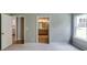 View of this bedroom's open doorways, neutral walls, and soft carpet flooring at 3855 Shelleydale Dr, Powder Springs, GA 30127