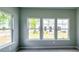 Light-filled bedroom featuring plush carpeting and large windows showcasing the outdoors at 3855 Shelleydale Dr, Powder Springs, GA 30127