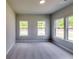 Bright bedroom with plush carpet and multiple windows offering scenic views at 3855 Shelleydale Dr, Powder Springs, GA 30127