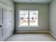 This bedroom features a large window overlooking the side yard, soft carpet floors and neutral colored walls at 3855 Shelleydale Dr, Powder Springs, GA 30127