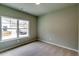 This bedroom features a window overlooking the front yard, soft carpet floors and neutral colored walls at 3855 Shelleydale Dr, Powder Springs, GA 30127