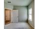 This bedroom features an exterior view through the window, and an open door leading to a hallway at 3855 Shelleydale Dr, Powder Springs, GA 30127