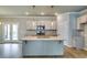 Modern kitchen featuring a large center island, stainless steel appliances, and stylish pendant lighting at 3855 Shelleydale Dr, Powder Springs, GA 30127