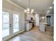 Open-concept kitchen with gray cabinets, stainless steel appliances, and an island, creating a modern and functional space at 3855 Shelleydale Dr, Powder Springs, GA 30127