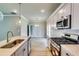Gourmet kitchen with an island, sleek countertops, modern appliances, and abundant lighting at 3855 Shelleydale Dr, Powder Springs, GA 30127