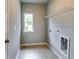 Functional laundry room with a window for natural light and shelving for storage, simplifying household chores at 3855 Shelleydale Dr, Powder Springs, GA 30127