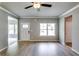 Spacious living area featuring hardwood floors, crown molding, and an abundance of natural light at 3855 Shelleydale Dr, Powder Springs, GA 30127