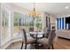 Bright dining area features a glass table, chandelier, and large windows overlooking the wooded area at 4147 Pinehurst Valley Dr, Decatur, GA 30034