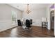 Elegant dining room with modern chandelier, glass table, and stylish black chairs at 4147 Pinehurst Valley Dr, Decatur, GA 30034