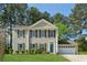 Charming two-story home with gray siding, dark shutters, and a well-manicured green lawn at 4147 Pinehurst Valley Dr, Decatur, GA 30034