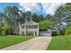 Traditional two-story home featuring a paved driveway, mature trees, and well-maintained lawn at 4147 Pinehurst Valley Dr, Decatur, GA 30034