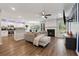 Open concept living room with fireplace, hardwood floors, and a kitchen view at 4147 Pinehurst Valley Dr, Decatur, GA 30034