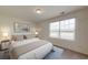 A bright bedroom with a large window is furnished with nightstands and a full bed and carpet at 7763 Sudbury Cir, Covington, GA 30014