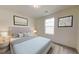 Comfortable bedroom with cool colors, featuring decorous wall art and accent lamps for a cozy ambiance at 7763 Sudbury Cir, Covington, GA 30014