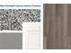 Showcasing home's interior finishes: gray-flecked granite counters, gray flooring, and bright white cabinets at 7763 Sudbury Cir, Covington, GA 30014