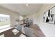 A spacious kitchen with stainless steel appliances and white cabinetry, connected to an open-plan dining area at 7763 Sudbury Cir, Covington, GA 30014