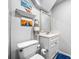 Cozy bathroom with white vanity, decorative mirror and artwork at 8885 N Mount Dr, Johns Creek, GA 30022