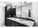 Modern bathroom with double sinks, quartz countertops, and vanity lighting at 8885 N Mount Dr, Johns Creek, GA 30022
