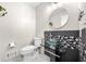 Modern bathroom with mosaic backsplash, glass vessel sink, and sleek fixtures at 8885 N Mount Dr, Johns Creek, GA 30022