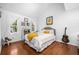 Bright bedroom with hardwood floors, large windows, queen bed, and a white and gray color palette at 8885 N Mount Dr, Johns Creek, GA 30022
