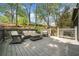 A deck area with cushioned seating and a small table offers an inviting outdoor space at 8885 N Mount Dr, Johns Creek, GA 30022