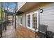 View of the deck with access to the house through french doors and seating area at 8885 N Mount Dr, Johns Creek, GA 30022