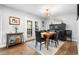 Elegant dining room with modern lighting, hardwood floors, and seating for six at 8885 N Mount Dr, Johns Creek, GA 30022