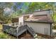 Exterior view of house with a deck. Set in a wooded area at 8885 N Mount Dr, Johns Creek, GA 30022