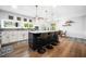 Modern kitchen with an island, seating, stainless steel appliances, and hardwood floors at 8885 N Mount Dr, Johns Creek, GA 30022