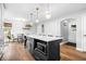 Open kitchen with an island, pendant lighting, hardwood floors, and stainless steel appliances at 8885 N Mount Dr, Johns Creek, GA 30022
