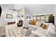 Sunlit living area is equipped with ample seating and a cozy rug at 8885 N Mount Dr, Johns Creek, GA 30022