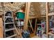 Unfinished attic space with exposed insulation and wooden beams, offering potential for customization or storage at 115 Batten Board Way Way, Woodstock, GA 30189