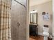 Well-lit bathroom with tiled shower, stylish shower curtain, and vanity with framed mirror at 115 Batten Board Way Way, Woodstock, GA 30189