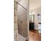 Bathroom featuring a tiled shower, dark vanity, wood floors and toilet at 115 Batten Board Way Way, Woodstock, GA 30189