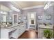 Spacious primary bathroom with dual vanities, granite countertops, and plenty of natural light at 115 Batten Board Way Way, Woodstock, GA 30189