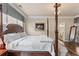 Bedroom featuring a four-poster bed, hardwood floors, a chandelier and ensuite bathroom at 115 Batten Board Way Way, Woodstock, GA 30189