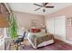 Cozy bedroom with a ceiling fan, neutral walls, and a large window for ample natural light at 115 Batten Board Way Way, Woodstock, GA 30189