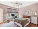 Bright bedroom featuring a ceiling fan, warm walls, and a window with woven shades at 115 Batten Board Way Way, Woodstock, GA 30189