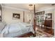 Bedroom featuring a four-poster bed, hardwood floors, a chandelier and ensuite bathroom at 115 Batten Board Way Way, Woodstock, GA 30189