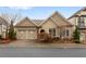 Charming home with a brick driveway and a well-manicured lawn at 115 Batten Board Way Way, Woodstock, GA 30189