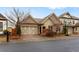 Attractive home with a brick driveway and detailed garage doors on a sunny day at 115 Batten Board Way Way, Woodstock, GA 30189